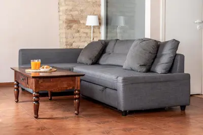 a living room with a grey couch and a coffee table at Angel House Vilnius, Dysnos in Vilnius