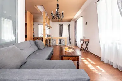 a living room with a couch and a table at Angel House Vilnius, Dysnos in Vilnius