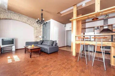 a living room with a couch and a table at Angel House Vilnius, Dysnos in Vilnius