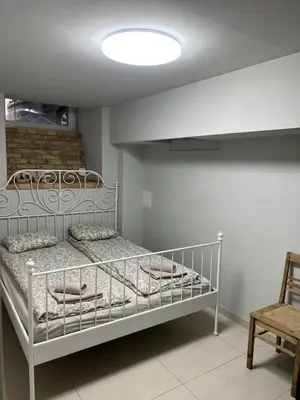 a bedroom with two bunk beds and a chair at Angel House Vilnius, Dysnos in Vilnius