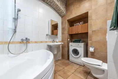 a bathroom with a toilet sink and a washing machine at Angel House Vilnius, Dysnos in Vilnius