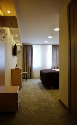 a hotel room with a bed and a window at Pasažo namai B&B in Raseiniai
