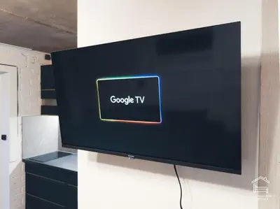 a flat screen tv hanging on a wall at Apartamentai Biržuose, cozy garage in Biržai