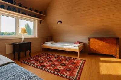 a room with a bed and a table and a window at Miguičionių sodyba in Migučionys