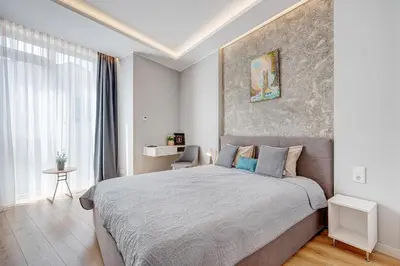 a bedroom with a large bed and a large window at HaPPy Inn Emporia, Self chek-in, Parking in the underground garage in Vilnius