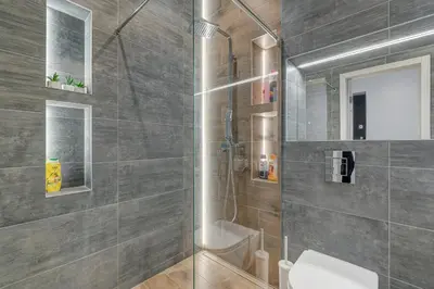 a bathroom with a shower and a toilet at HaPPy Inn Emporia, Self chek-in, Parking in the underground garage in Vilnius