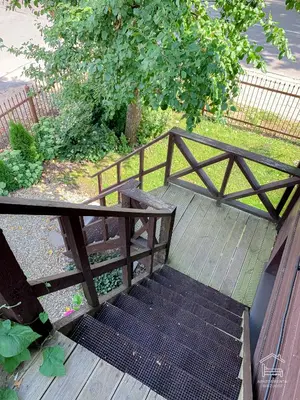 a wooden stairway with a wooden railing and a stair case at Apartamentai Biržuose, double bedroom and single bedroom Apartments in Biržai