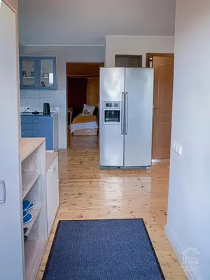 a kitchen with a white refrigerator in a room at Apartamentai Biržuose, double bedroom and single bedroom Apartments in Biržai