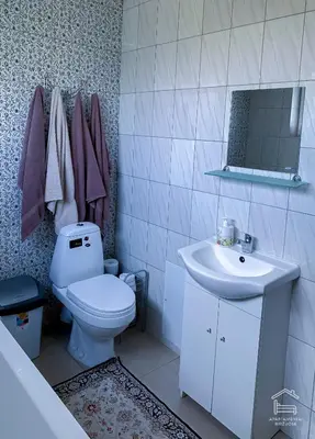 a bathroom with a toilet and a sink and a mirror at Apartamentai Biržuose, double bedroom and single bedroom Apartments in Biržai
