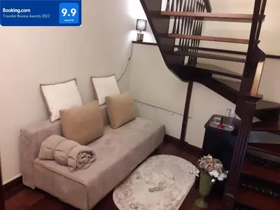 a couch in a living room with a staircase at Old Town Gate Residence in Vilnius