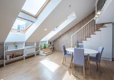 a kitchen and dining room with a skylight at A. Vienuolio gatvė Apartamentai in Vilnius