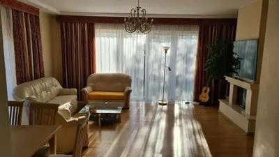 a living room with a couch and a table and a tv at Sofia apartments, 6 rooms, 260m2 in Vilnius
