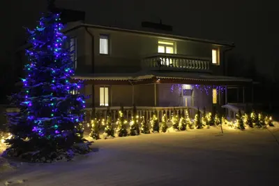 a christmas tree in front of a house with lights at Sofia apartments, 6 rooms, 260m2 in Vilnius