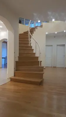 a staircase in a white room with wooden floors at Sofia apartments, 6 rooms, 260m2 in Vilnius