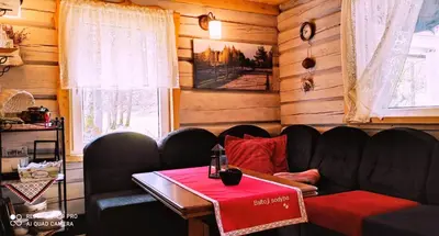 a living room with a couch and a table at White homestead in Sumiliszki