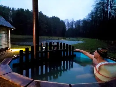 a man swimming in a pool of water at White homestead in Sumiliszki