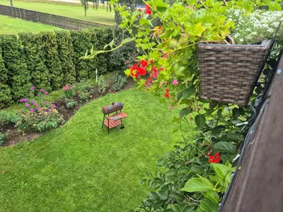 an aerial view of a garden with a bench and flowers at Apartamentai pas Danutę in Prienai