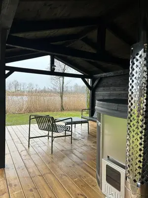 two benches sitting on a deck with a grill at VieniKrante in Utena