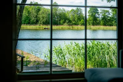 a view of a lake through a window at VieniKrante in Utena