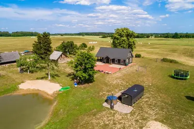 an aerial view of a house and a camp site at Family house Vila Rica in Ricieliai