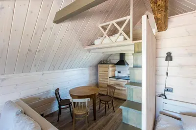 a room with a table and chairs in a cabin at Family house Vila Rica in Ricieliai