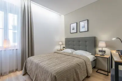 a bedroom with a bed and a large window at COME2rest - Stikliu 20 in Vilnius