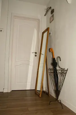 a mirror and an umbrella in front of a door at A perfect base to explore Vilnius! in Vilnius