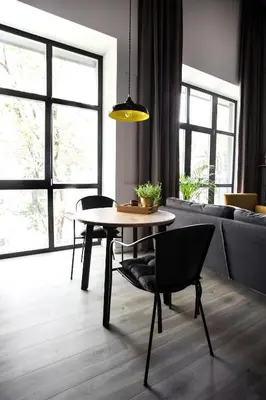 a living room with a table and chairs and a couch at G - Owl Jazz -Modern loft type apartment 18 with big roof terrace and free private parking in Kaunas