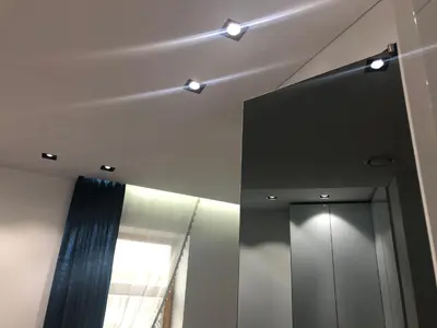 a bathroom with a mirror and lights on the ceiling at Modern and Luxury Apartment in the Center of Kaunas in Kaunas