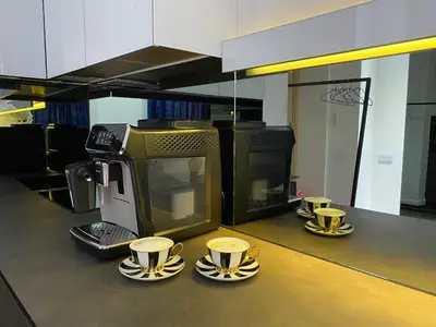 a counter with three cups of coffee on saucers at Modern and Luxury Apartment in the Center of Kaunas in Kaunas