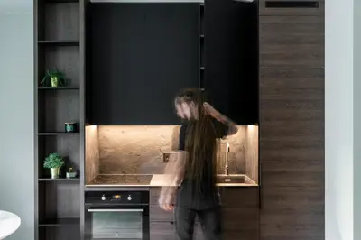 a man is standing in a kitchen at Modern boutique apartment in the city center in Druskininkai
