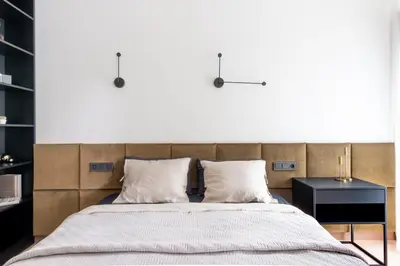 a bedroom with a large bed and a side table at Modern boutique apartment in the city center in Druskininkai