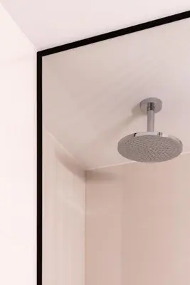 a ceiling light in front of a mirror at Modern boutique apartment in the city center in Druskininkai