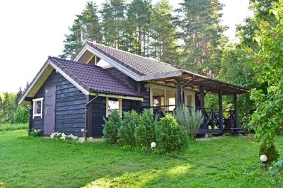a small house in a field with trees at Šeimos namelis - Mindūnų sodyba in Mindūnai