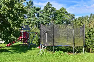 a basketball hoop with a net in a yard at Šeimos namelis - Mindūnų sodyba in Mindūnai