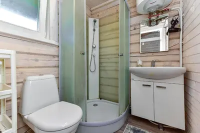a small bathroom with a toilet and a sink at Šeimos namelis - Mindūnų sodyba in Mindūnai