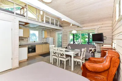 a kitchen and dining room with a table and chairs at Šeimos namelis - Mindūnų sodyba in Mindūnai