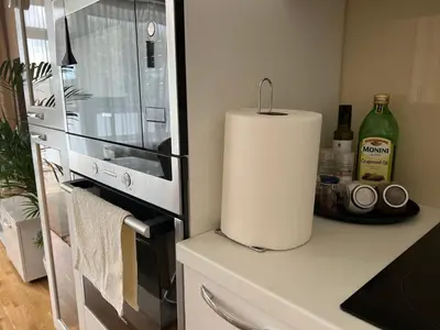 a kitchen with a counter with a refrigerator and a candle at Antakalnis 5 stars apartment in Vilnius