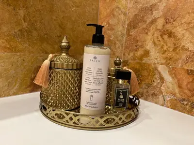 a gold tray with a bottle of soap and a soap dispenser at Antakalnis 5 stars apartment in Vilnius