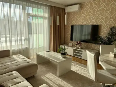 a living room with a couch and a tv at Antakalnis 5 stars apartment in Vilnius
