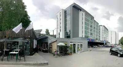 a building on a city street with tables and chairs at Antakalnis 5 stars apartment in Vilnius