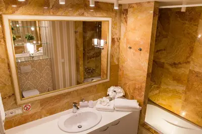 a bathroom with a sink and a mirror at Antakalnis 5 stars apartment in Vilnius
