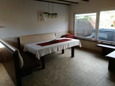 a dining room with a table and a window at Mini spa Harmonija in Zapyškis