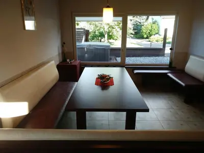 a living room with a table and a couch at Mini spa Harmonija in Zapyškis