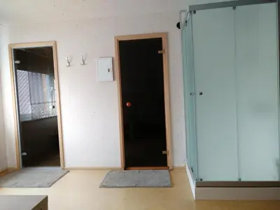 a room with a black door and a mirror at Mini spa Harmonija in Zapyškis