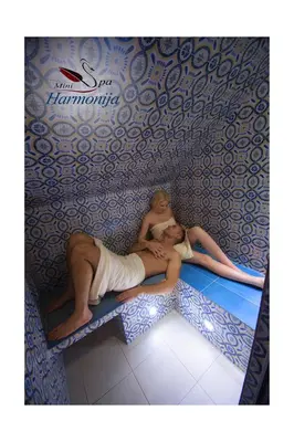 a man and a woman laying on a bench at Mini spa Harmonija in Zapyškis
