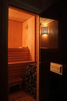 a room with a sauna with a bench and a light at Mini spa Harmonija in Zapyškis