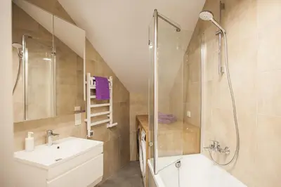 a bathroom with a shower and a sink at Penthouse in the City Center in Vilnius