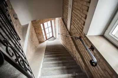 a staircase in a building with a window at Penthouse in the City Center in Vilnius