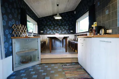 a kitchen with a table and a dining room at Kliukai in Dubingiai